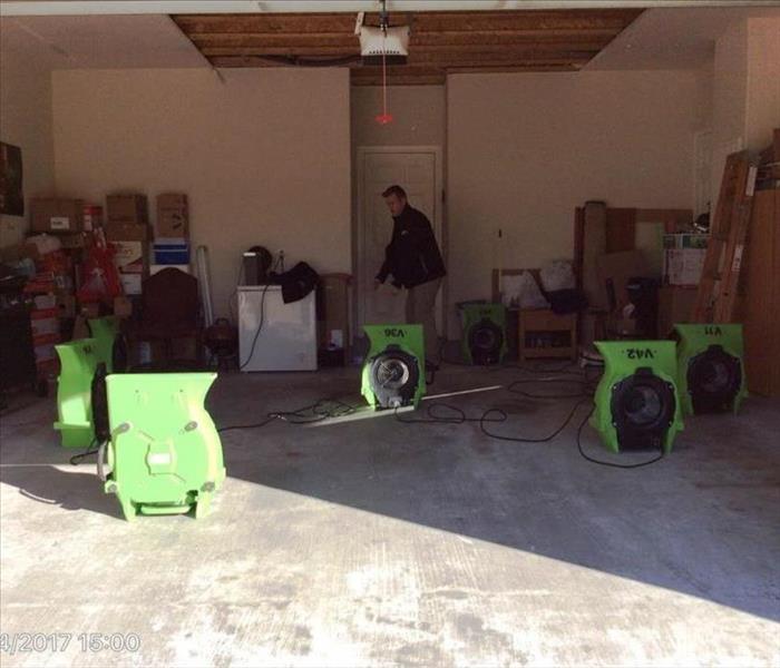 servpro drying equipment on a cement floor