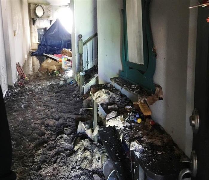 severe fire damage in the hallway of a home
