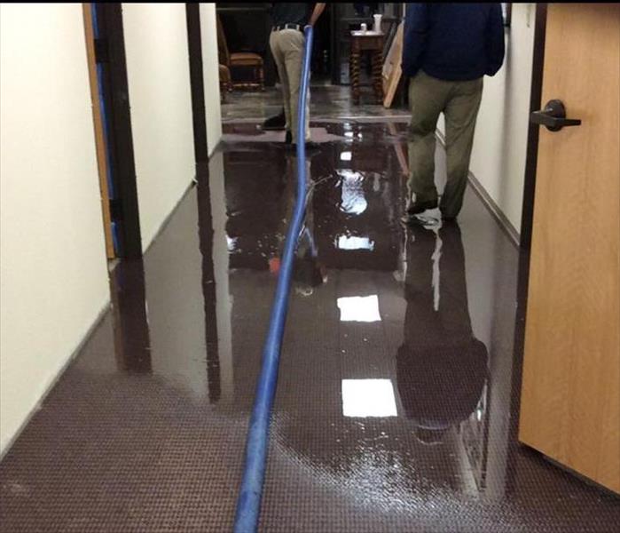 crew extracting water from the hallway