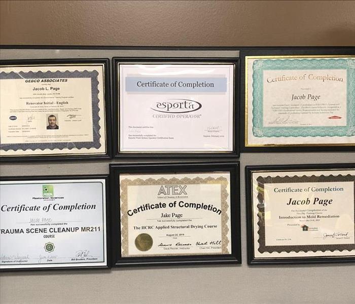 certificates and awards on a wall